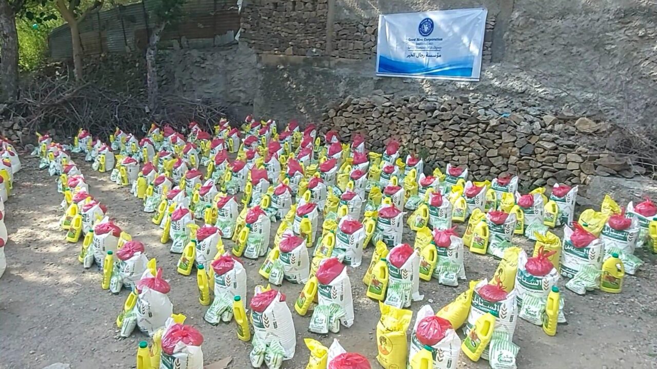 July 23, 2026 Good Men Corp distribution - Food baskets arranged beneath the GMC banner